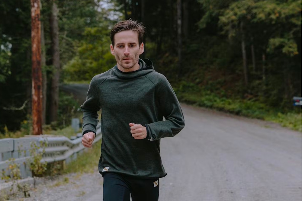 tracksmith downeaster hoodie on man running down road