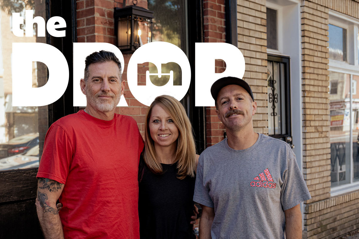 the drop podcasts hosts standing in front of a building