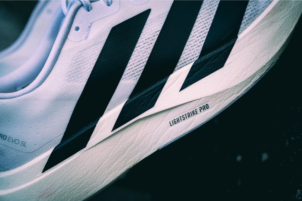 adidas three strips on a white shoe