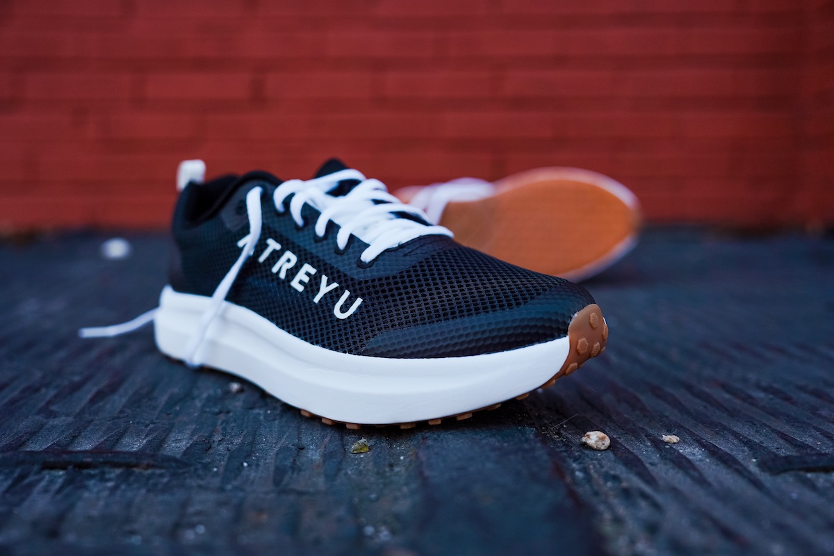 black shoe with a brick wall background