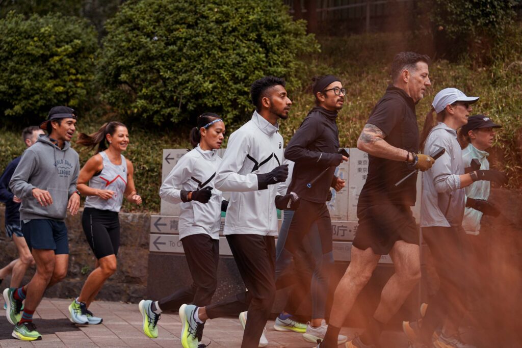 group of runners on a sidewalk