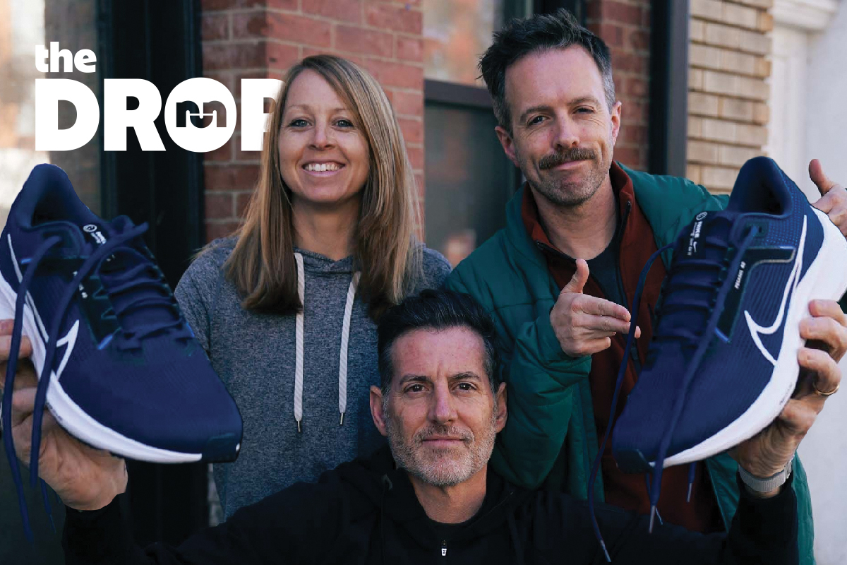 a man holding nike pegasus 40 with a man over his left shoulder and a women over his right shoulder