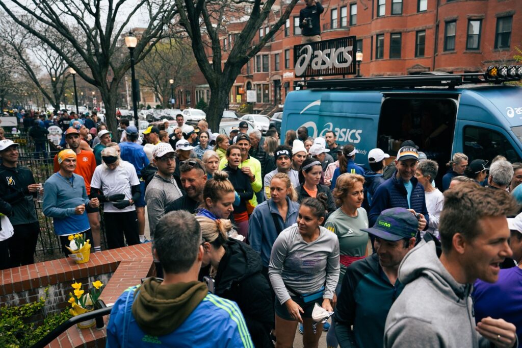 large crowd of people with van in background