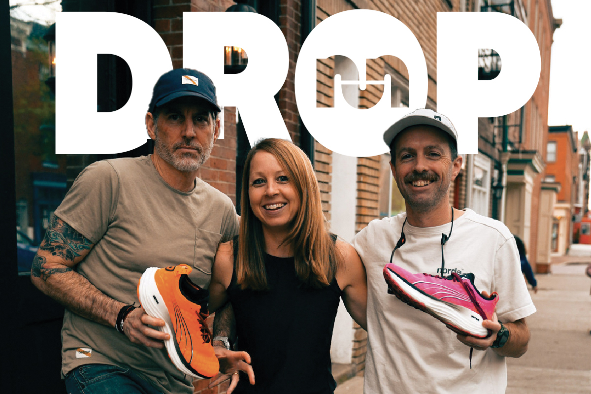 two men holding puma shoes on left and right with a woman in between