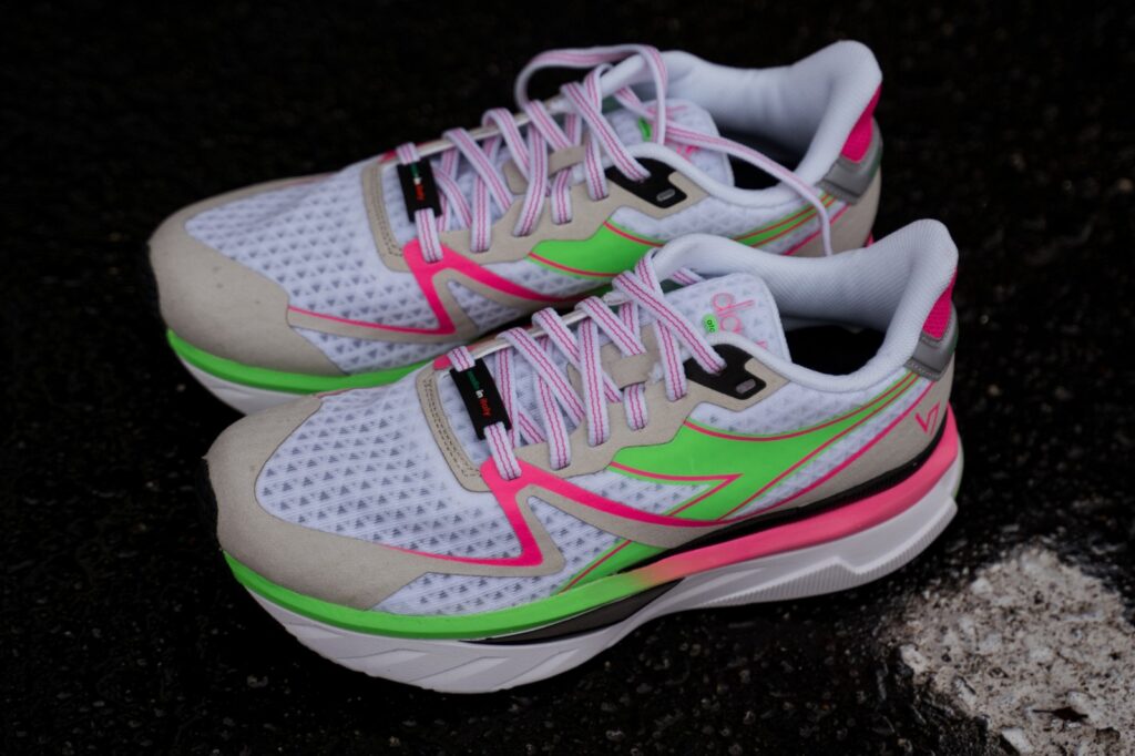 looking down on the neon pink and green colorway of women's diadora atomo v7000