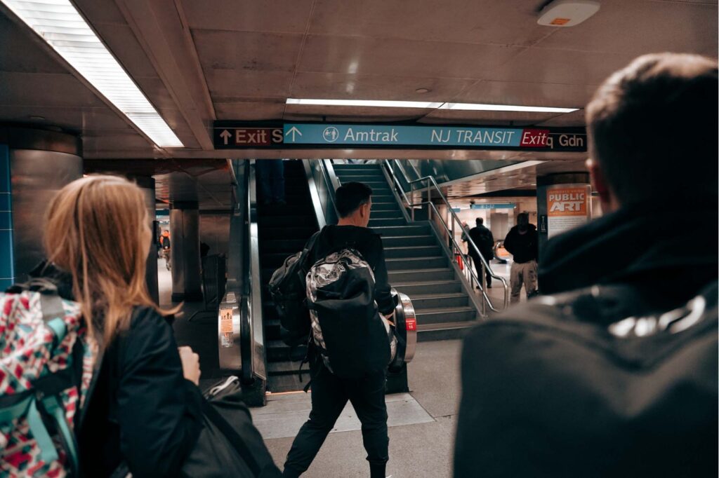 man walking through amtrak trian station with a set of stairs in the background