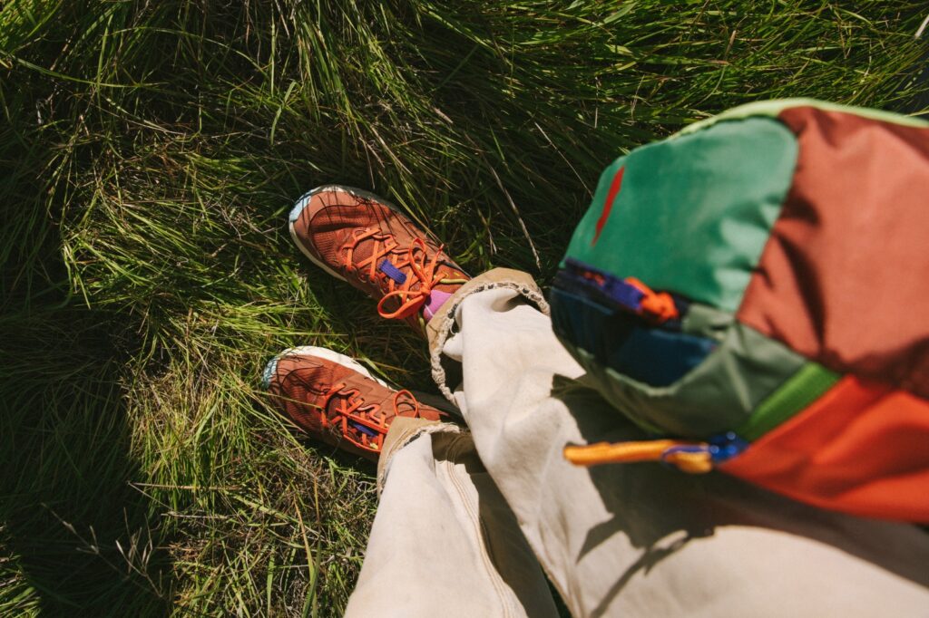photo looking down on top of hoka anacapa trail shoes in grass