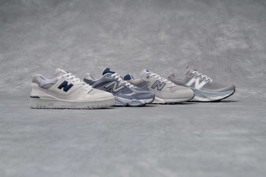 four grey new balance shoes in a row on grey background