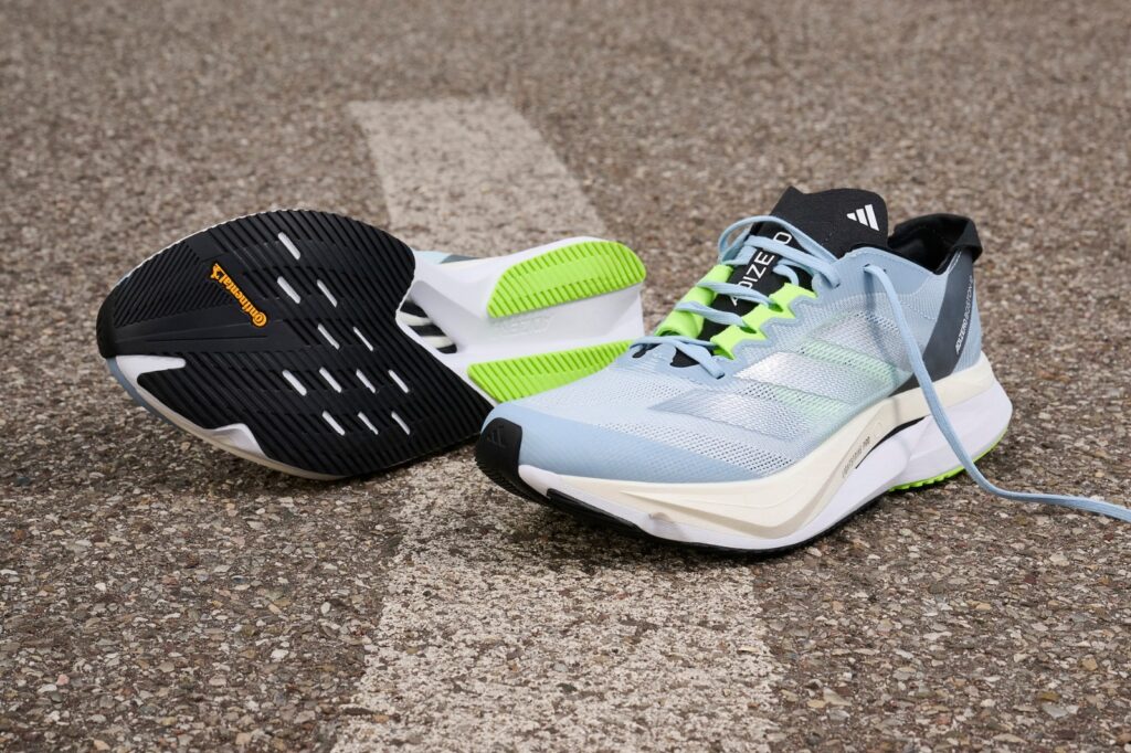 two adidas boston 12 shoes in a parking lot