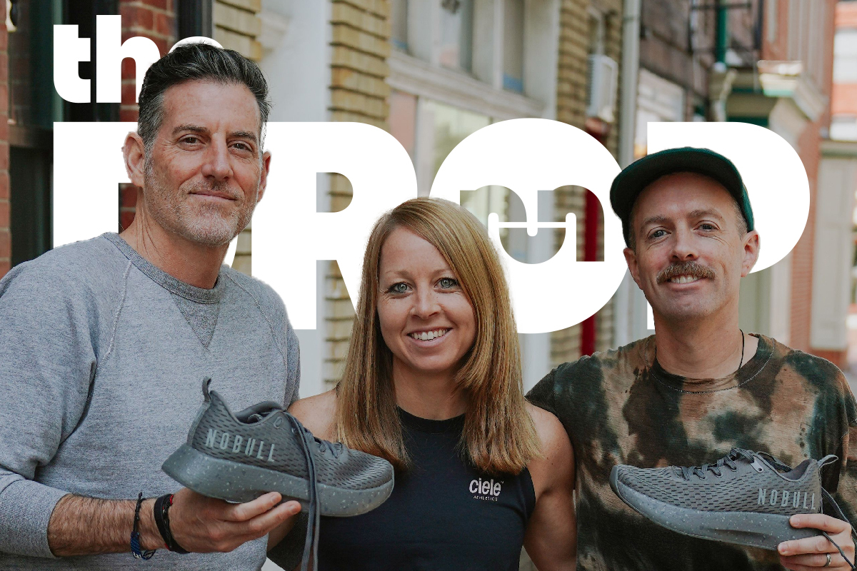 man on left and right holding shoes with smiling woman in the middle