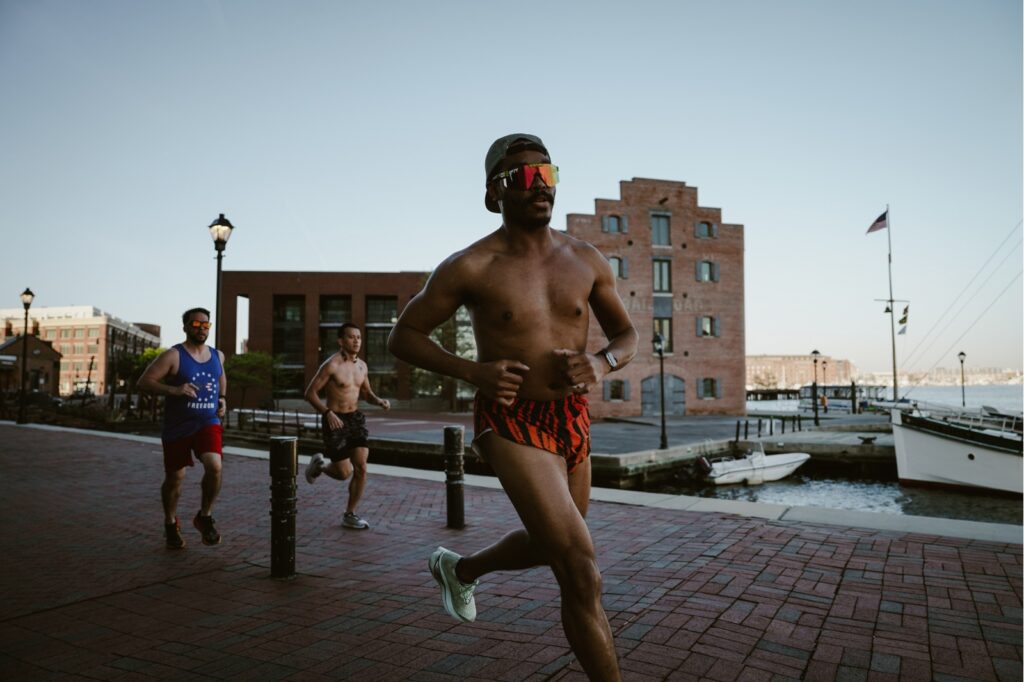 man running with cityscape in the background