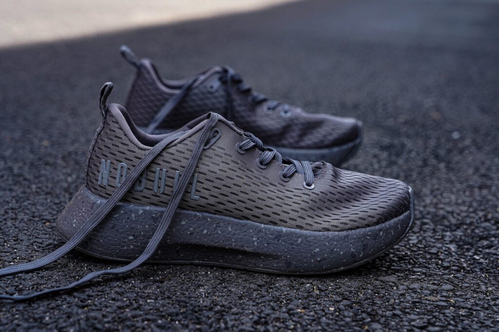 grey nobull runner+ shoe in the middle of an alley