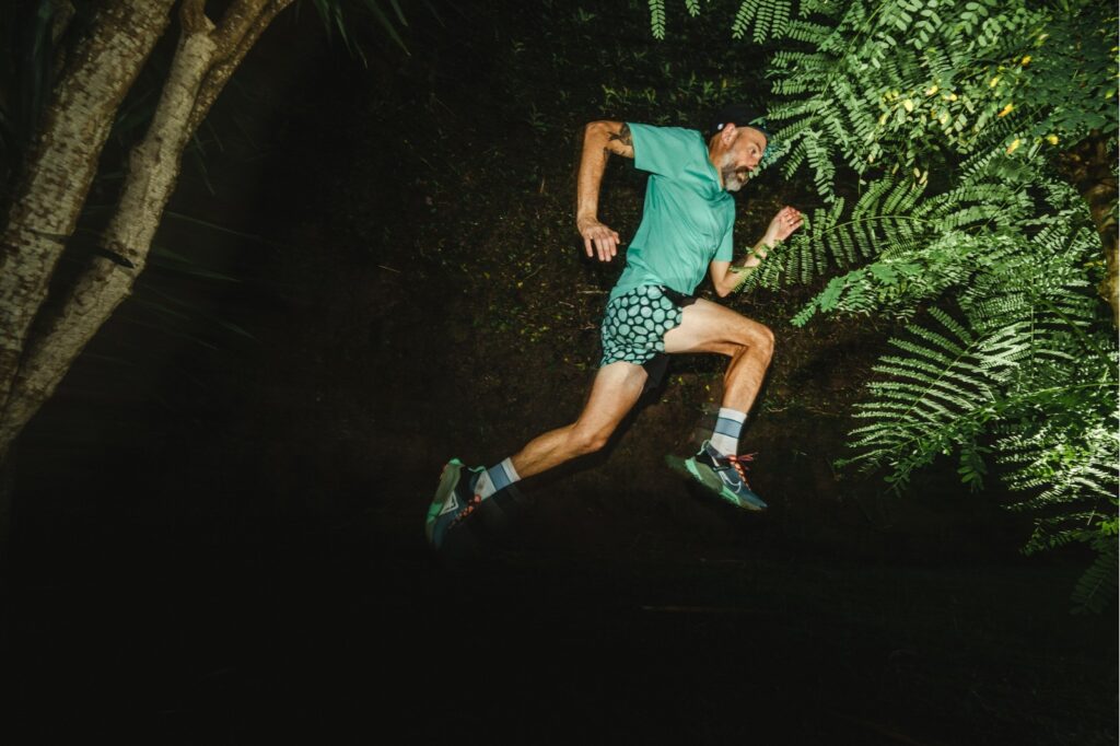 man running through the woods at night