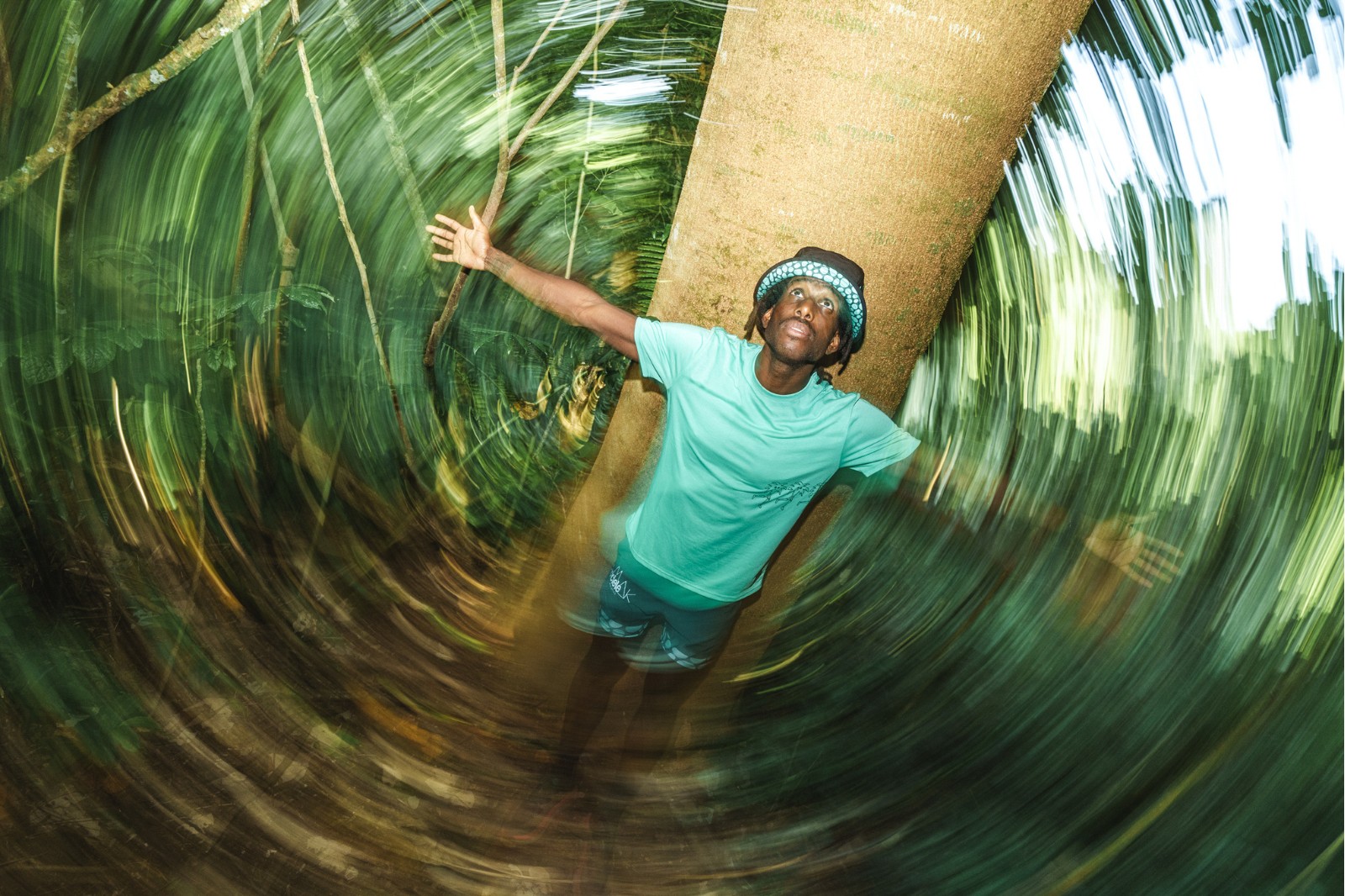 man standing in the woods with arms outstretched