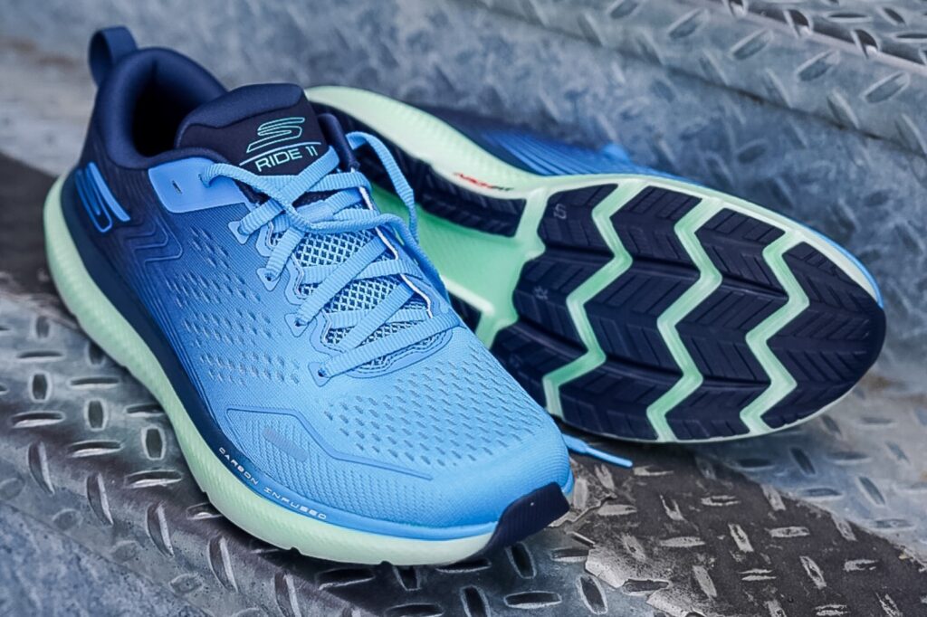 light blue skechers running shoes sitting on a metal stair