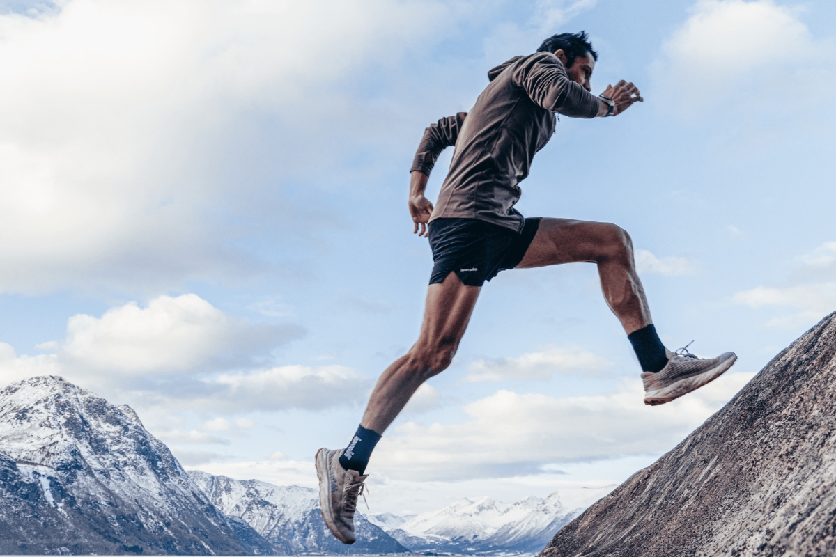 man running up a mountain