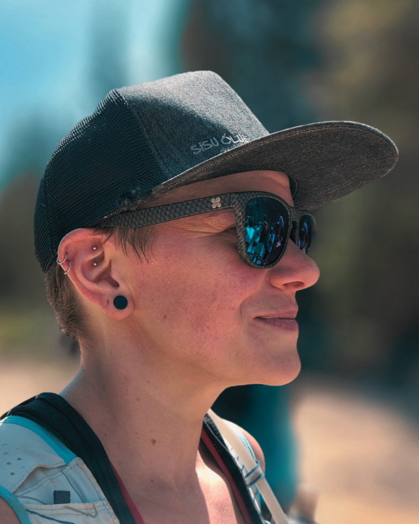 A woman wearing sunglasses and a hat.