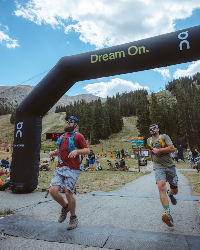 two men finishing a trail race