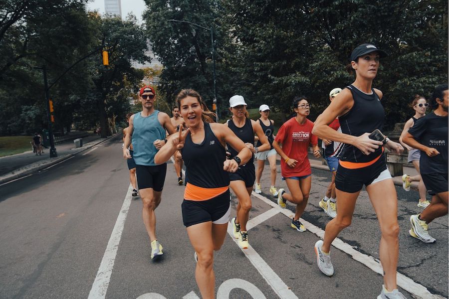 woman running with other people smiling