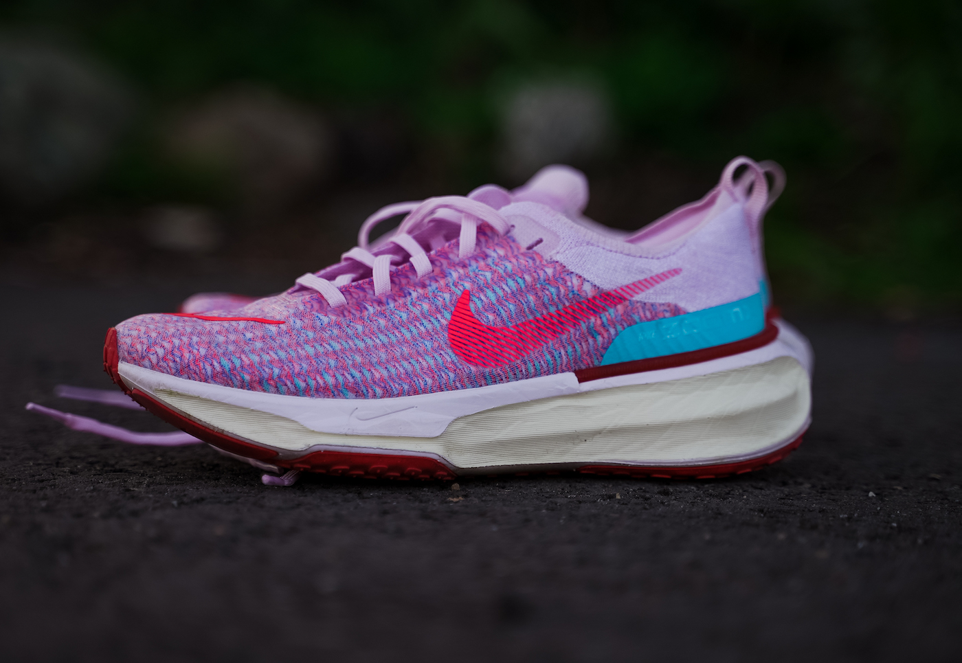 nike zoomx invincible 3 pink upper sitting on pavement