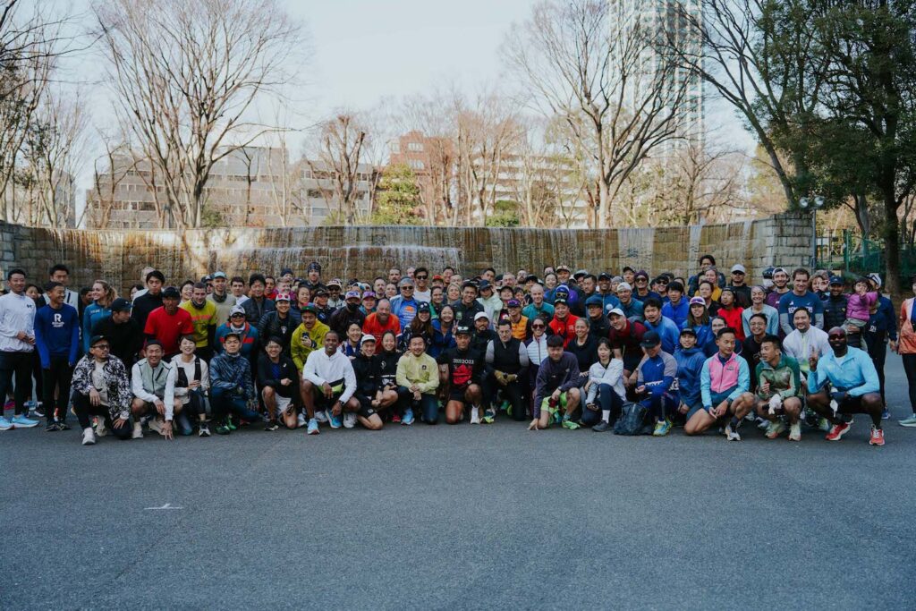 group of runners posing for a photo in a park
