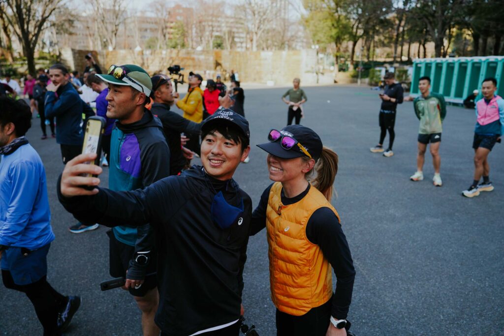man taking a selfie with a woman after a running event