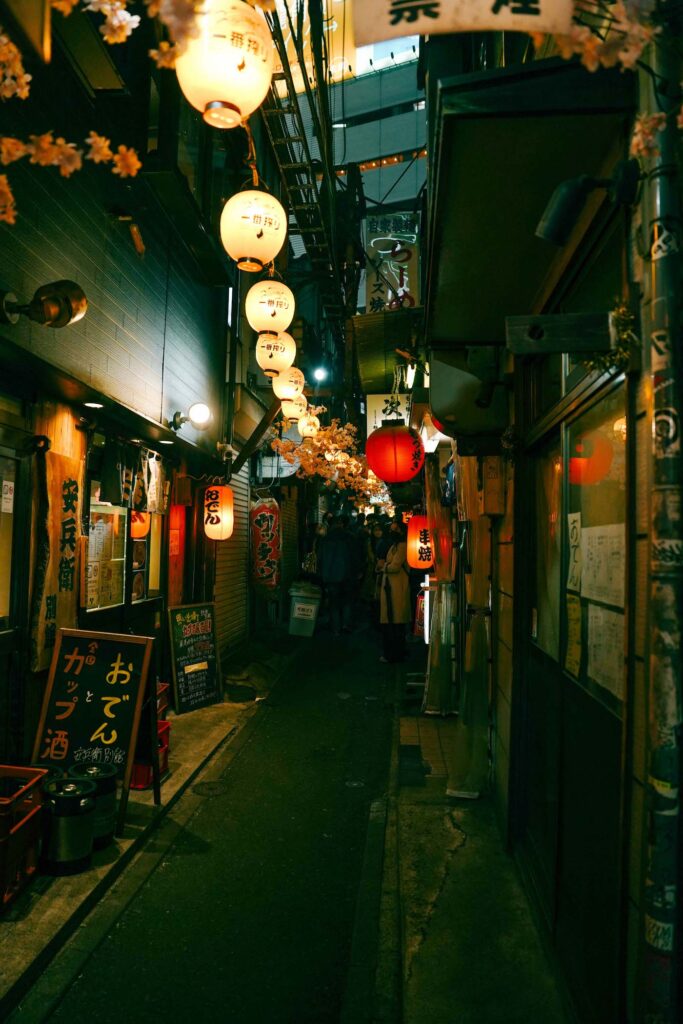 night alley in tokyo with hanging lanterns
