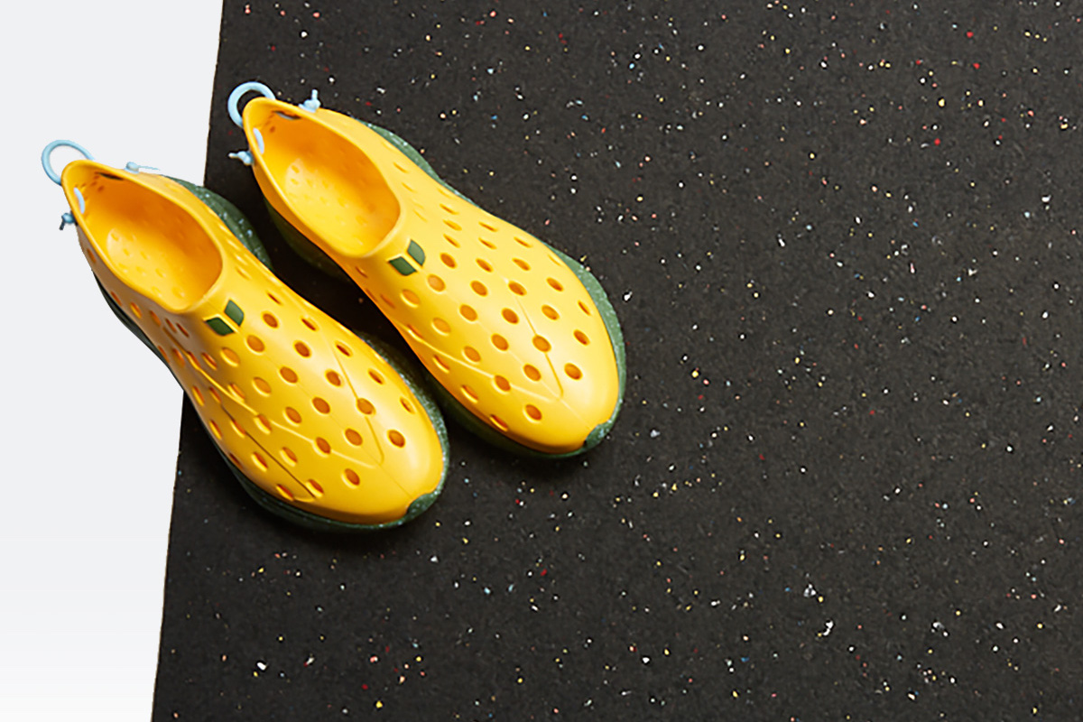 yellow kane recovert shoes on a black yoga mat