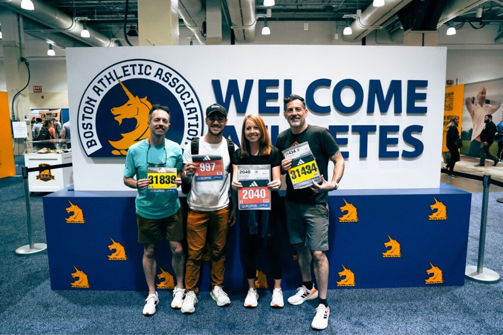 standing with bibs at the boston marathon expo