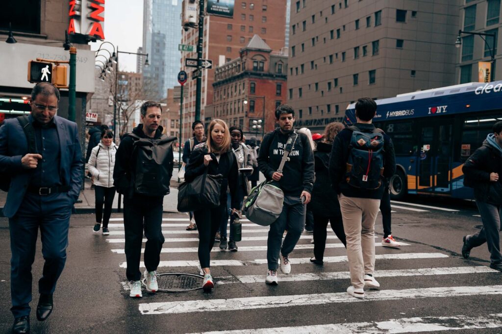 people walking through a crosswalk in new york city