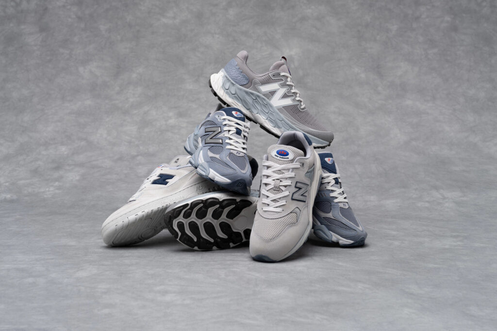 pile of grey new balance shoes on a grey background