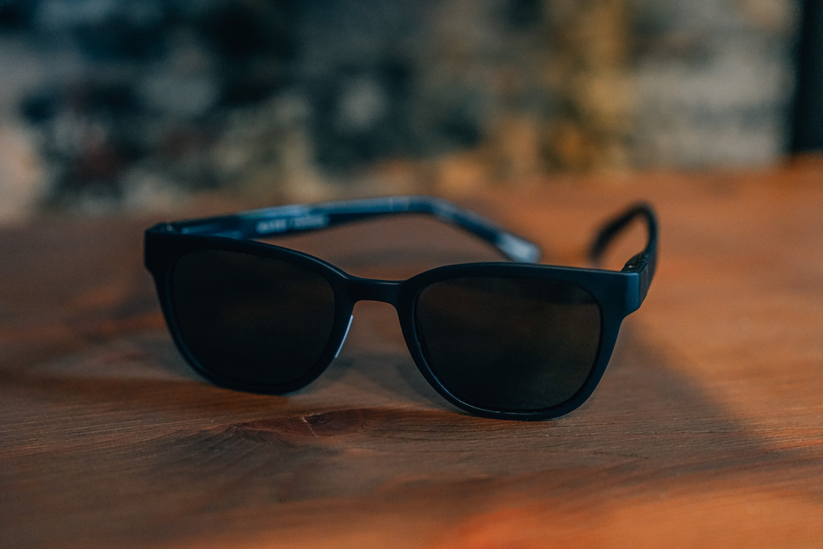 black Warby Parker Sunglasses on a wooden table