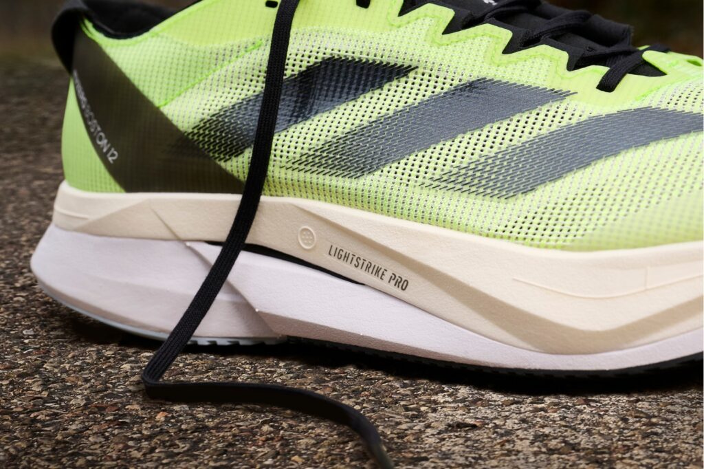 closeup of the lateral side of a neon yellow adidas boston 12