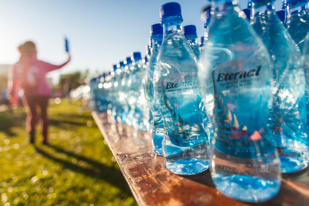 photo of water bottles on a table in the sunlight after