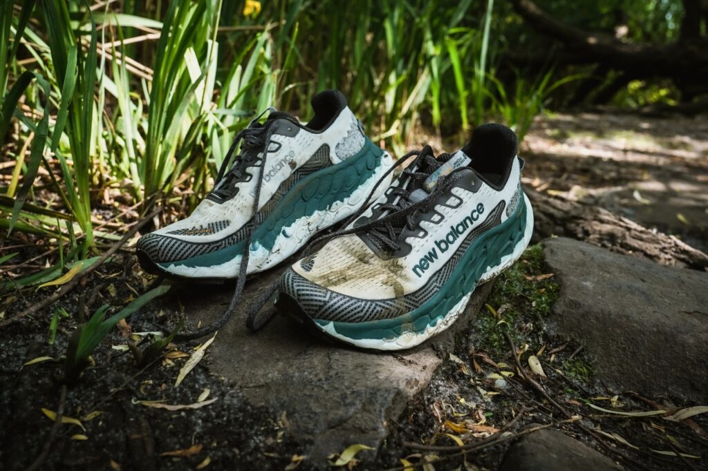 new balance trail shoes on a muddy trail