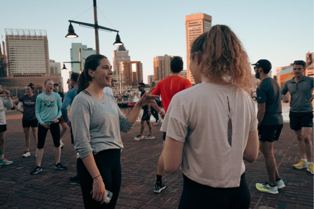 two women in running clothes talking to each other
