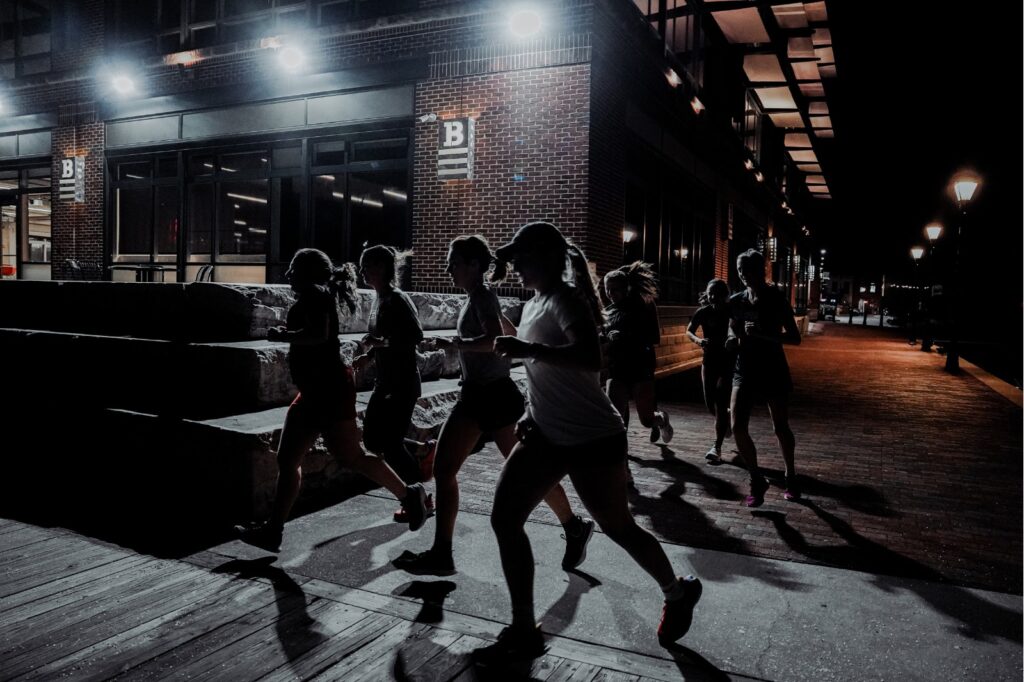 group of women running at night