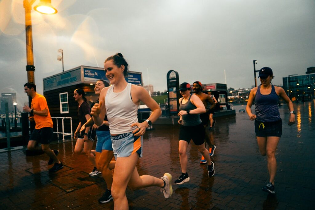 group of women running during a rainstorm