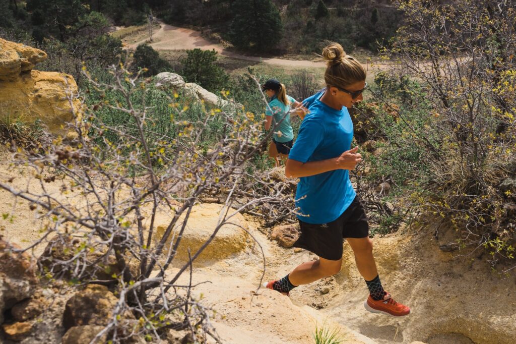 woman in blue shirt trail running