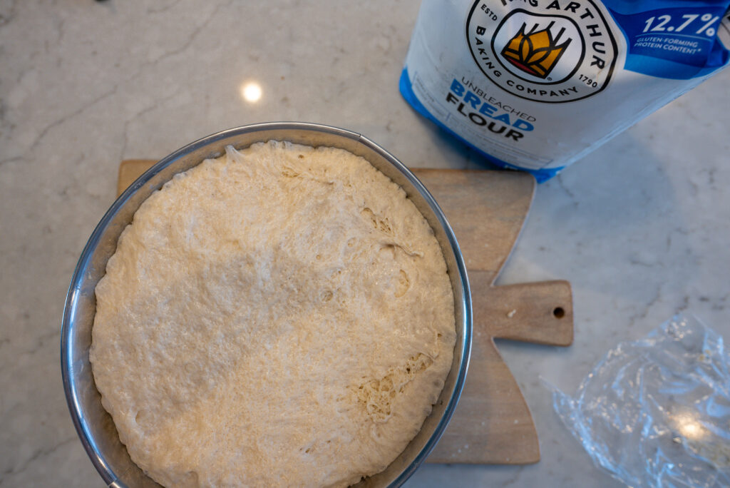 Bagel dough rising in bowl