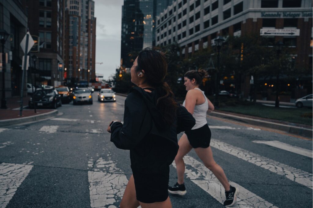 woman running in a crosswalk in the city