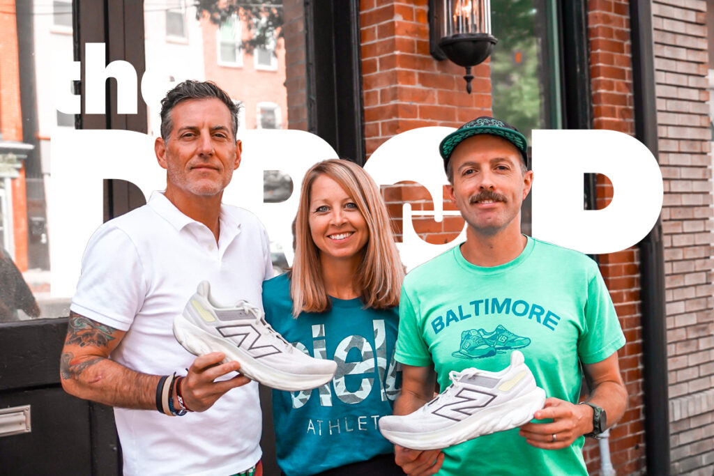 man on left holding white new balance shoe, woman in center, man on right in green shirt holding white new balance shoe