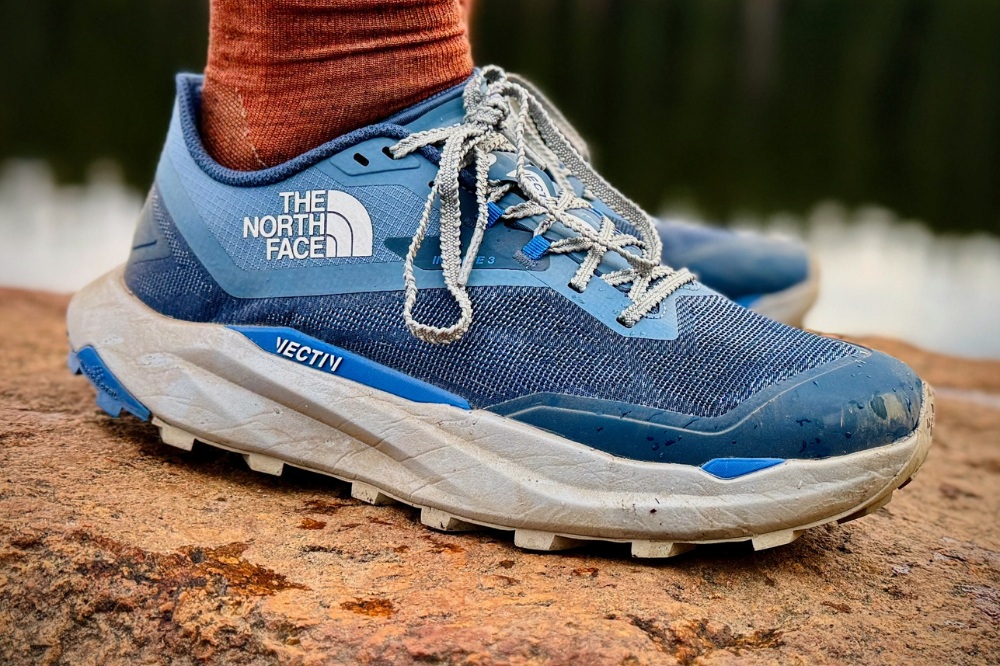 the north face vectiv infinite 3 - standing on rock